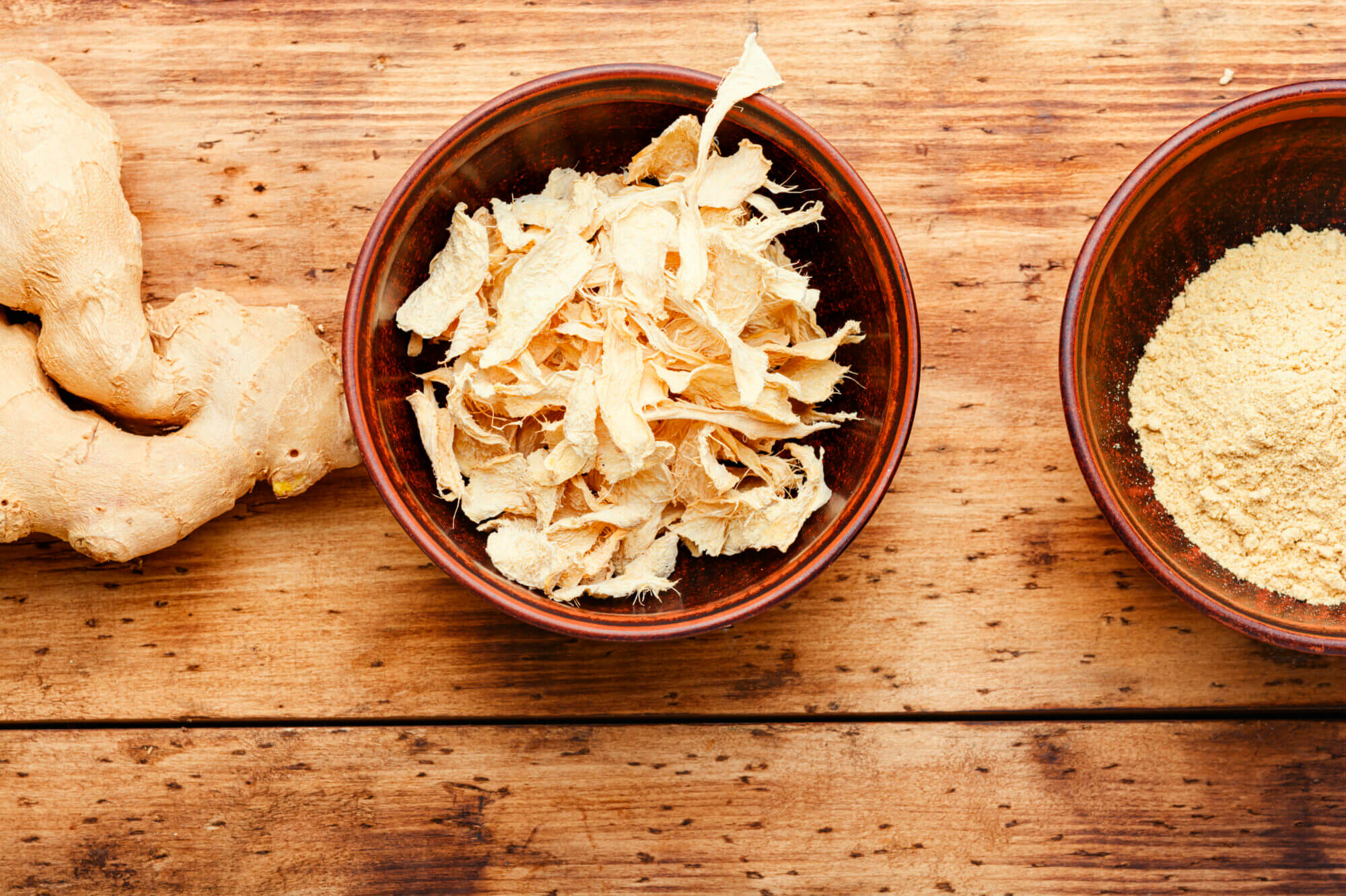 Dried organic ginger on rustic wooden background